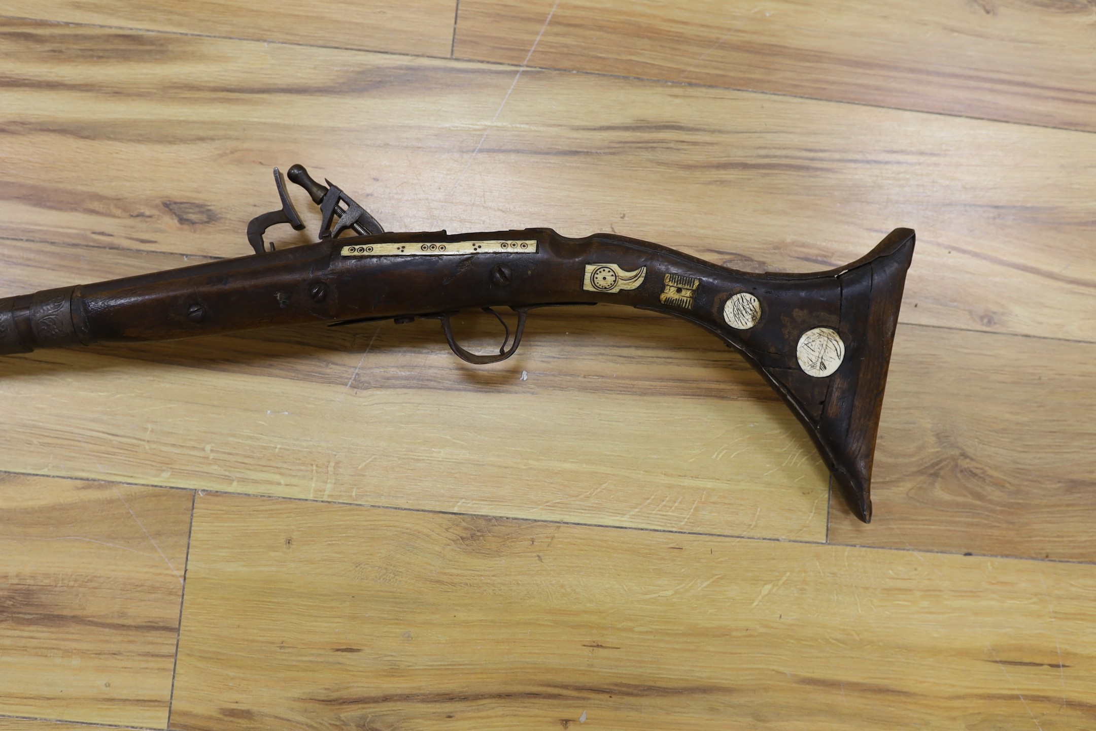 An Eastern antique flintlock rifle - 152cm long